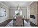Elegant dining room with brick fireplace, chandelier, and hardwood floors at 2908 Mabry Ne Ln, Brookhaven, GA 30319