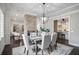Open dining room with gray table, fireplace, and kitchen view at 2908 Mabry Ne Ln, Brookhaven, GA 30319