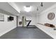 Bright home gym featuring a treadmill, TV, rubber flooring, and minimalist design for a clean and functional space at 2908 Mabry Ne Ln, Brookhaven, GA 30319