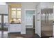 Kitchen area with a wet bar, stainless fridge, and access to the entry area at 2908 Mabry Ne Ln, Brookhaven, GA 30319
