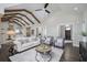 Spacious open-concept living room boasts natural light, vaulted ceiling, wood beams, and hardwood floors at 2908 Mabry Ne Ln, Brookhaven, GA 30319