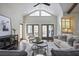 Bright living room with vaulted ceilings, clerestory windows, fireplace, and access to outdoor area at 2908 Mabry Ne Ln, Brookhaven, GA 30319