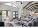 Open-concept living room showcases vaulted ceiling, wood beams, fireplace, and access to kitchen at 2908 Mabry Ne Ln, Brookhaven, GA 30319