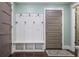 Mudroom with a coat rack, bench, and storage cubbies by a gray door at 2908 Mabry Ne Ln, Brookhaven, GA 30319