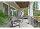 Inviting covered porch with rocking chairs, a bench, and a view of the landscaped yard at 2908 Mabry Ne Ln, Brookhaven, GA 30319