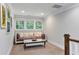 A cozy sitting area with multiple windows and a comfortable sofa piled with decorative pillows, great for relaxation at 2908 Mabry Ne Ln, Brookhaven, GA 30319