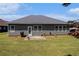 The backyard features a gray house, a lawn, and a concrete patio area at 3634 Cape Ln, Conyers, GA 30013