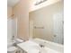 Bright bathroom featuring a large mirror, white vanity, toilet, and a shower-tub combo at 3634 Cape Ln, Conyers, GA 30013