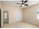 Bright bedroom with a closet, ceiling fan, carpet, and a hallway view at 3634 Cape Ln, Conyers, GA 30013