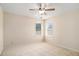 Bright, carpeted bedroom with natural light from two windows and a ceiling fan at 3634 Cape Ln, Conyers, GA 30013