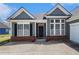 Inviting home featuring large front windows and brick accents, creating a warm and welcoming atmosphere at 3634 Cape Ln, Conyers, GA 30013