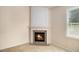 Cozy fireplace is set into a corner with tile surround and painted mantel at 3634 Cape Ln, Conyers, GA 30013