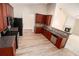 Functional kitchen with cherry cabinets, stainless appliances, and open layout to living spaces at 3634 Cape Ln, Conyers, GA 30013