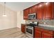 Well-equipped kitchen features wood cabinets, stainless steel appliances, and a tiled backsplash at 3634 Cape Ln, Conyers, GA 30013