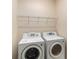 Functional laundry room with modern washer and dryer set and convenient overhead shelving at 3634 Cape Ln, Conyers, GA 30013