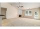Bright living room boasts a fireplace and ceiling fan with lots of natural light at 3634 Cape Ln, Conyers, GA 30013