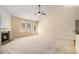 Inviting living room featuring a fireplace, ceiling fan, and lots of natural light at 3634 Cape Ln, Conyers, GA 30013