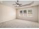 Generous main bedroom features a ceiling fan, tray ceiling, and lots of windows at 3634 Cape Ln, Conyers, GA 30013