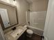 Bathroom featuring a modern vanity with granite counters, and a shower-tub combo with tiled enclosure at 42 Woodhaven Path, Rockmart, GA 30153