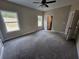 Large bedroom with a ceiling fan, carpeted floor, and lots of natural light from two windows at 42 Woodhaven Path, Rockmart, GA 30153