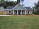 Charming single-story home featuring a well-manicured lawn, inviting facade, and classic architectural details at 42 Woodhaven Path, Rockmart, GA 30153