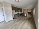Modern kitchen with stainless steel appliances, wooden cabinets, and an open design connecting to the living area at 42 Woodhaven Path, Rockmart, GA 30153