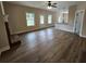 Bright living room showcasing hardwood floors, a fireplace, and a seamless transition into the kitchen area at 42 Woodhaven Path, Rockmart, GA 30153