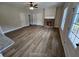 Spacious living room featuring a brick fireplace, ceiling fan, and multiple windows for natural light at 42 Woodhaven Path, Rockmart, GA 30153