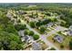 Aerial view of a lush neighborhood with well-maintained homes, mature trees, and a tranquil lake nearby at 450 Bay Grove Se Rd, Loganville, GA 30052
