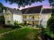 Expansive backyard with a multi-tiered deck, a stone patio, and beautifully landscaped garden beds at twilight at 450 Bay Grove Se Rd, Loganville, GA 30052