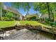 Secluded backyard featuring a stone patio, mature trees, and meticulously landscaped gardens, creating a private oasis at 450 Bay Grove Se Rd, Loganville, GA 30052