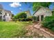A peaceful backyard featuring a charming studio, mature trees and a lush green lawn at 450 Bay Grove Se Rd, Loganville, GA 30052