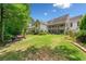 Expansive backyard with a covered patio, a spacious lawn, and a two-story deck, ideal for entertaining at 450 Bay Grove Se Rd, Loganville, GA 30052