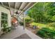 Backyard with a covered patio, lush greenery, and a detached building at 450 Bay Grove Se Rd, Loganville, GA 30052