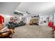 Large finished basement with multiple seating areas and decorative sports-themed elements at 450 Bay Grove Se Rd, Loganville, GA 30052
