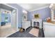 Bright bathroom featuring double sinks, and decorative fireplace, with an open doorway to another room at 450 Bay Grove Se Rd, Loganville, GA 30052