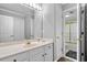 Well-lit bathroom featuring a large mirror and a separate toilet and shower at 450 Bay Grove Se Rd, Loganville, GA 30052