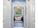 Elegant bathroom featuring a soaking tub, a decorative chandelier, and natural light from the window at 450 Bay Grove Se Rd, Loganville, GA 30052