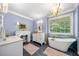 Stylish bathroom with a freestanding tub, double sinks, unique fixtures, and an ornate decorative fireplace at 450 Bay Grove Se Rd, Loganville, GA 30052