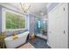 Elegant bathroom featuring a freestanding tub, a glass shower, modern fixtures, and stylish tile flooring with natural light at 450 Bay Grove Se Rd, Loganville, GA 30052