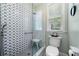 Updated bathroom with patterned shower tiling, a glass shower door, and a modern toilet at 450 Bay Grove Se Rd, Loganville, GA 30052