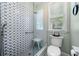 Modern bathroom with tiled shower, glass door, and efficient toilet with window at 450 Bay Grove Se Rd, Loganville, GA 30052