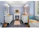 Aesthetic bathroom with double sinks, a freestanding tub, decorative fireplace, and modern fixtures and finishes at 450 Bay Grove Se Rd, Loganville, GA 30052