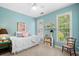 Bright bedroom features a ceiling fan, light blue walls, and natural light at 450 Bay Grove Se Rd, Loganville, GA 30052