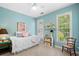 Bright blue bedroom boasts ample natural light from two windows at 450 Bay Grove Se Rd, Loganville, GA 30052