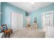 Bright bedroom featuring a large closet, neutral carpet, and light blue walls at 450 Bay Grove Se Rd, Loganville, GA 30052