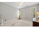 Bedroom with neutral carpet, two windows, and ceiling fan at 450 Bay Grove Se Rd, Loganville, GA 30052