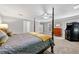 The bedroom features a four poster bed, a ceiling fan, and an arcade game at 450 Bay Grove Se Rd, Loganville, GA 30052