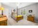 Cozy bedroom with neutral walls, natural light and elegant wooden furniture at 450 Bay Grove Se Rd, Loganville, GA 30052