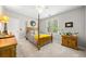 Cozy bedroom with four-poster bed, neutral walls, and bright natural light at 450 Bay Grove Se Rd, Loganville, GA 30052